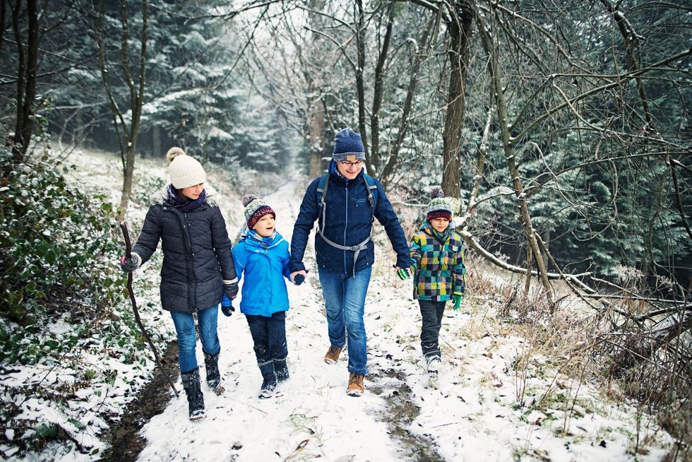 family walking in the snow