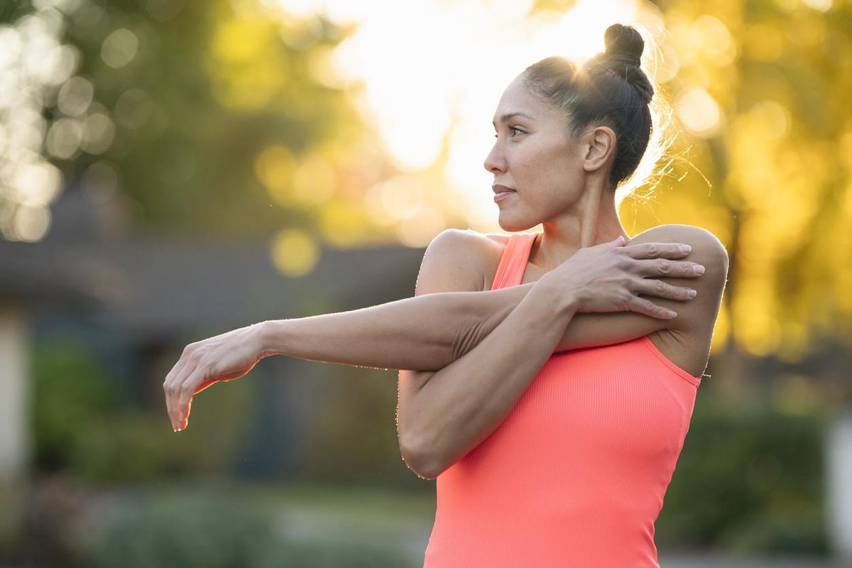 female athlete stretching before outdoor workout