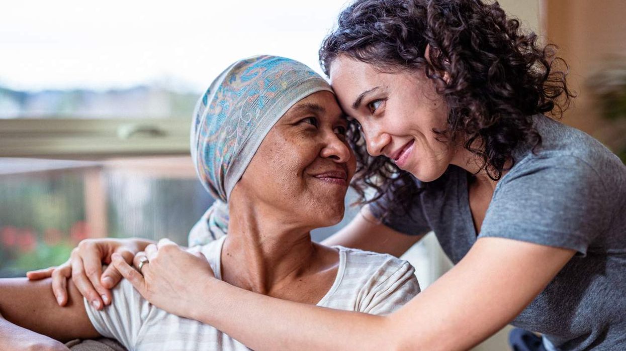 Female cancer patient hugs adult daughter