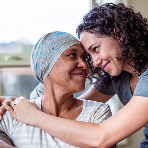 Female cancer patient hugs adult daughter