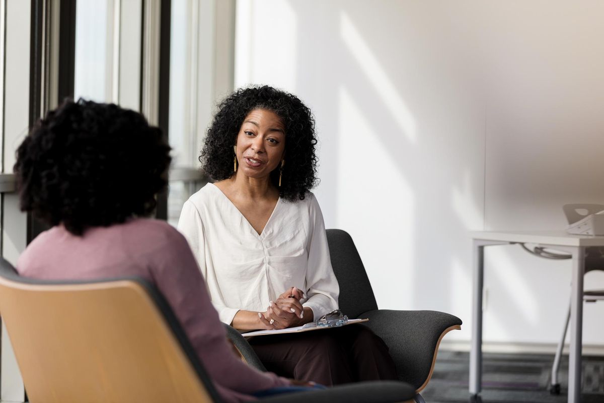 Female counselor talks with female patient