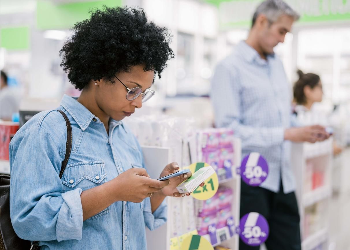 Female customer buying medicine in drugstore