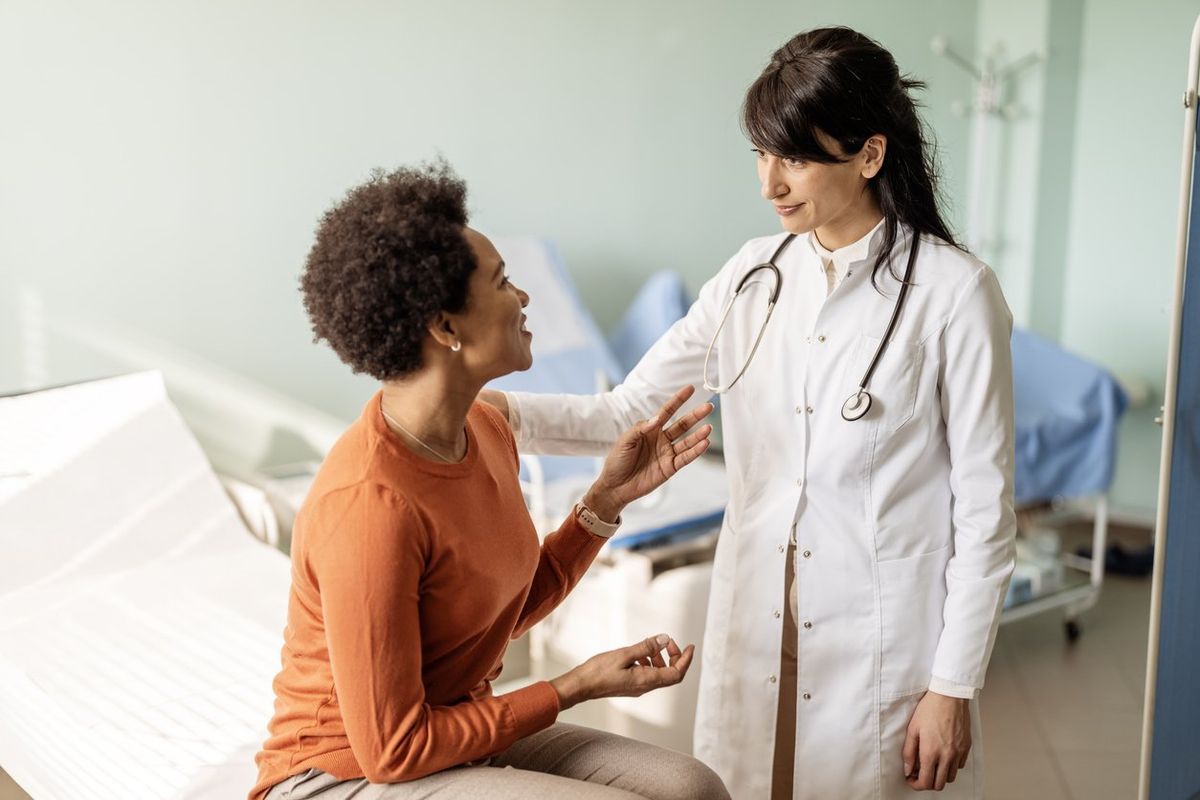Female doctor listening in comfort during a consultation inside her office