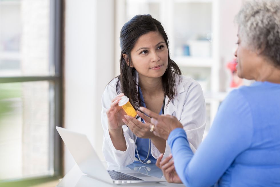 Female doctor listens to patient's prescription questions