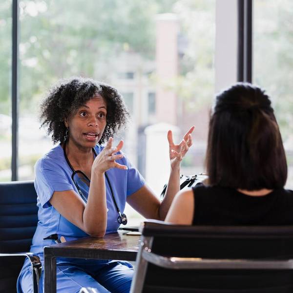 Female doctor talking with female patient