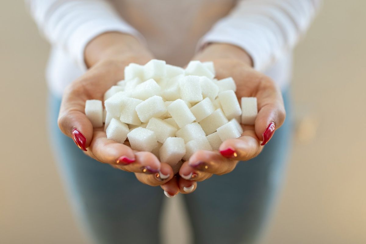 Female hands holding sugar cubes