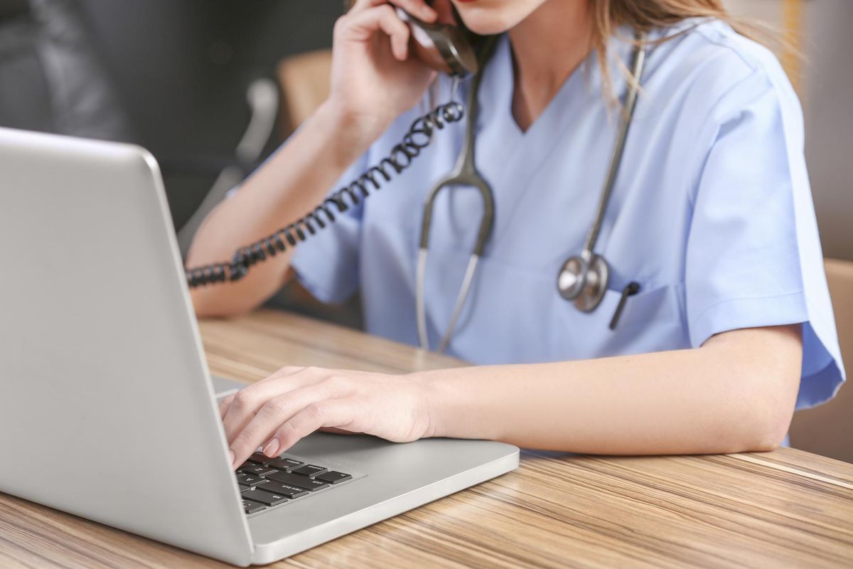 Female healthcare professional uses a laptop