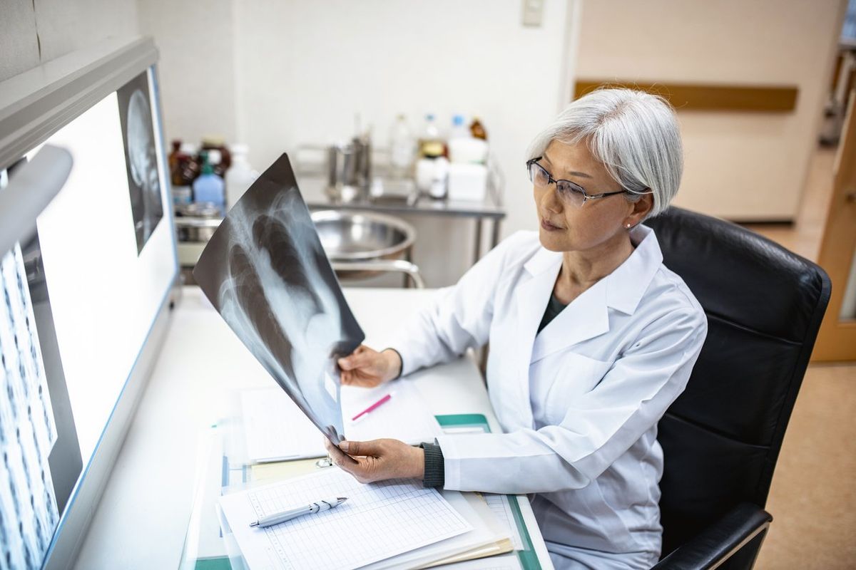 Female Japanese Physician Studying X-Ray Imagery