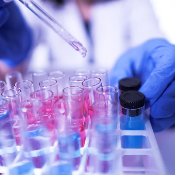Female lab technician doing research with a microscope in the lab