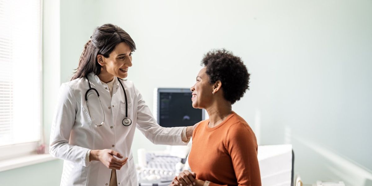 Female medical practitioner reassuring a patient