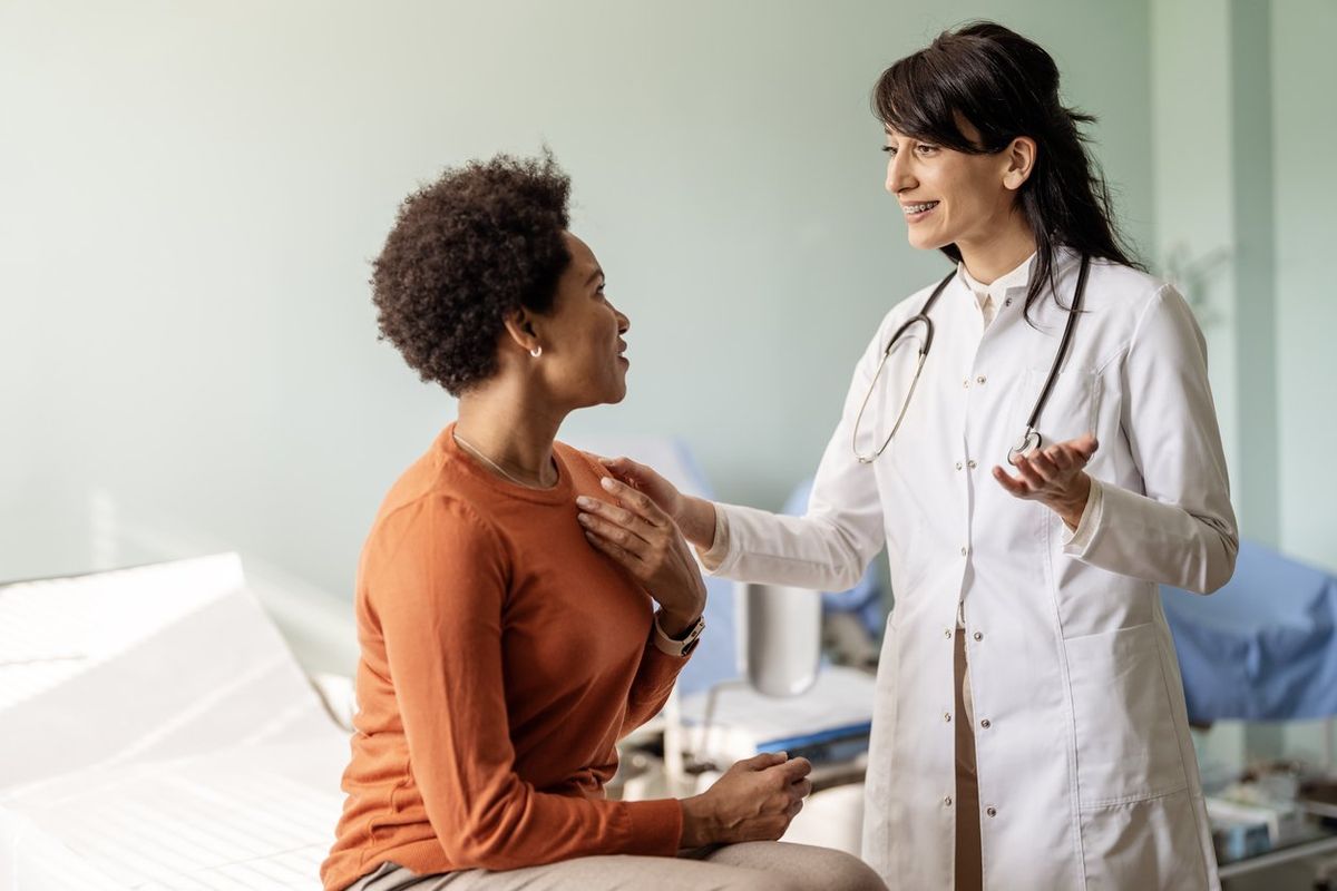 Female patient speaking with her doctor in a doctors office