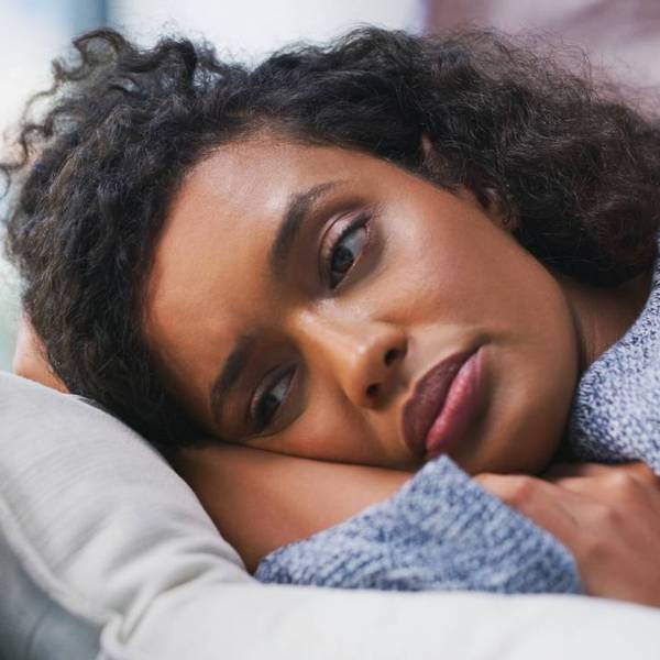 female person lying on couch with pmdd
