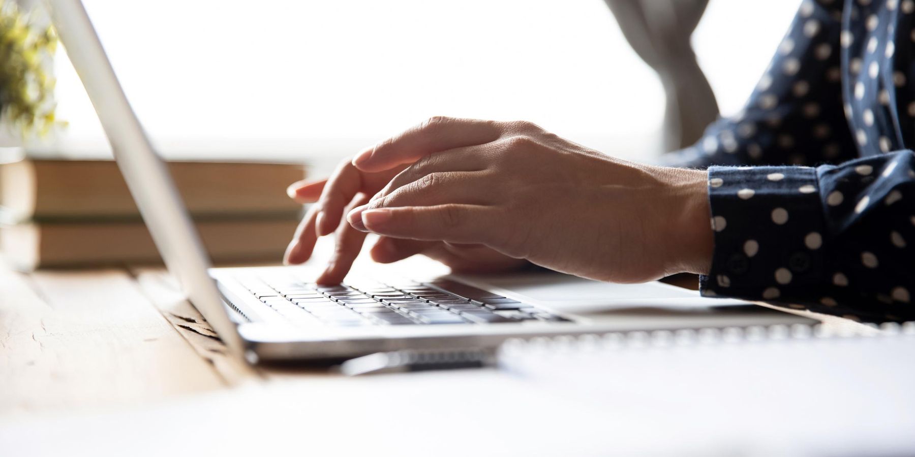 Female professional student using laptop at desk, close up view