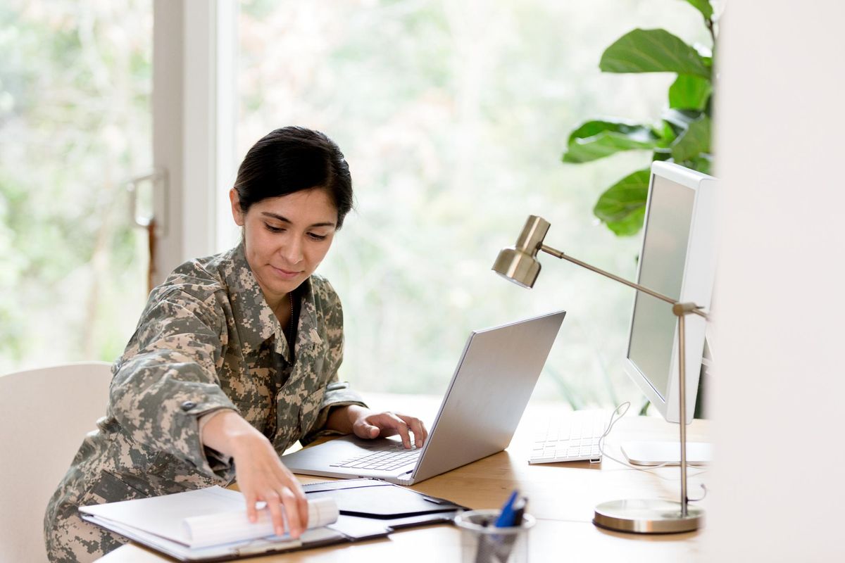 Female soldier works on home finances