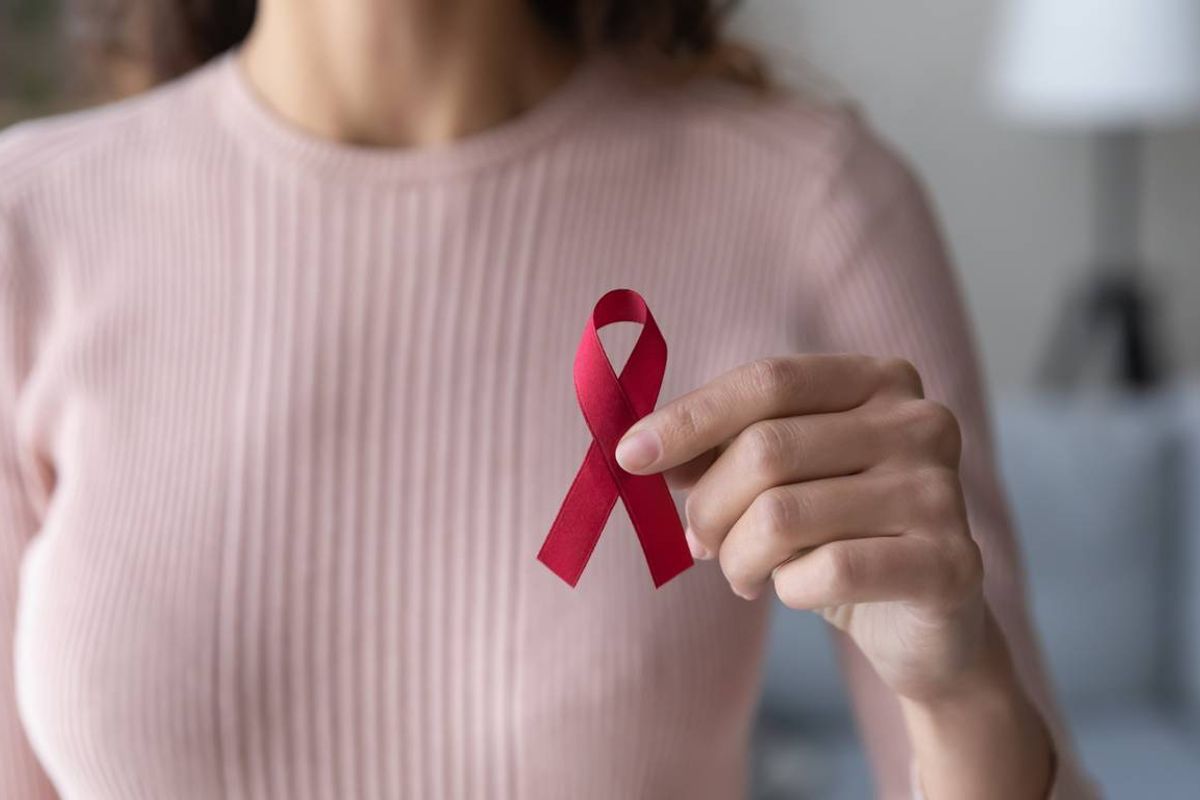female volunteer holding red ribbon