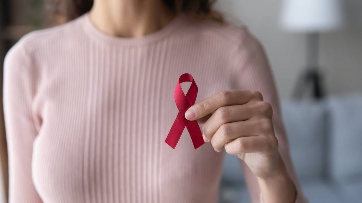 female volunteer holding red ribbon