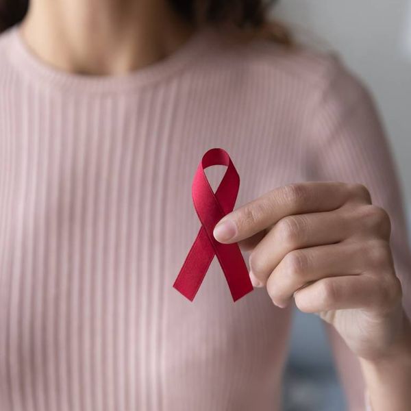 female volunteer holding red ribbon