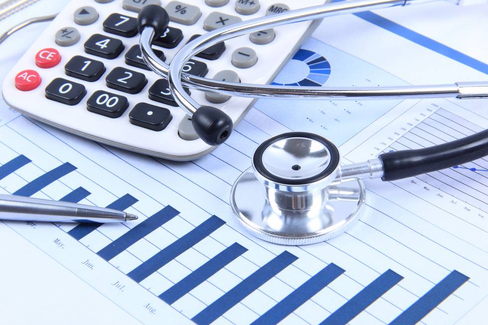 Financial statement with stethoscope and calculator