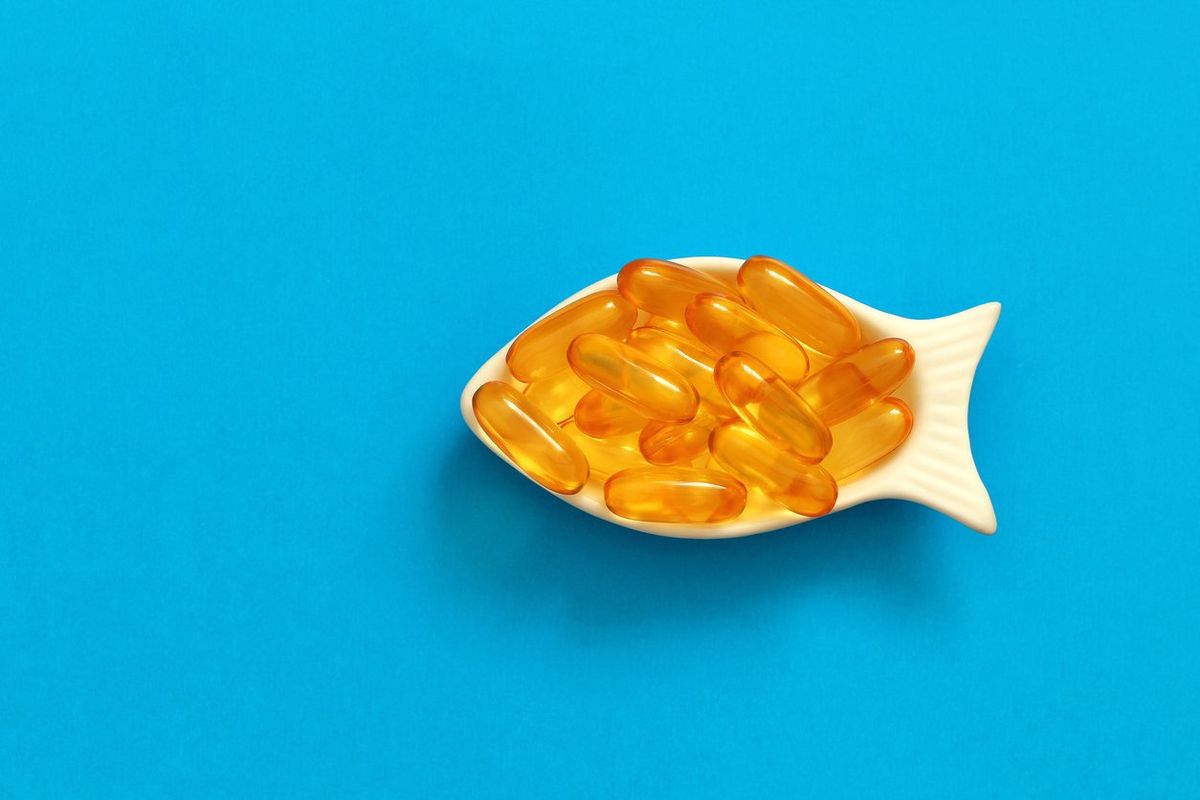 fish oil capsules on a blue background