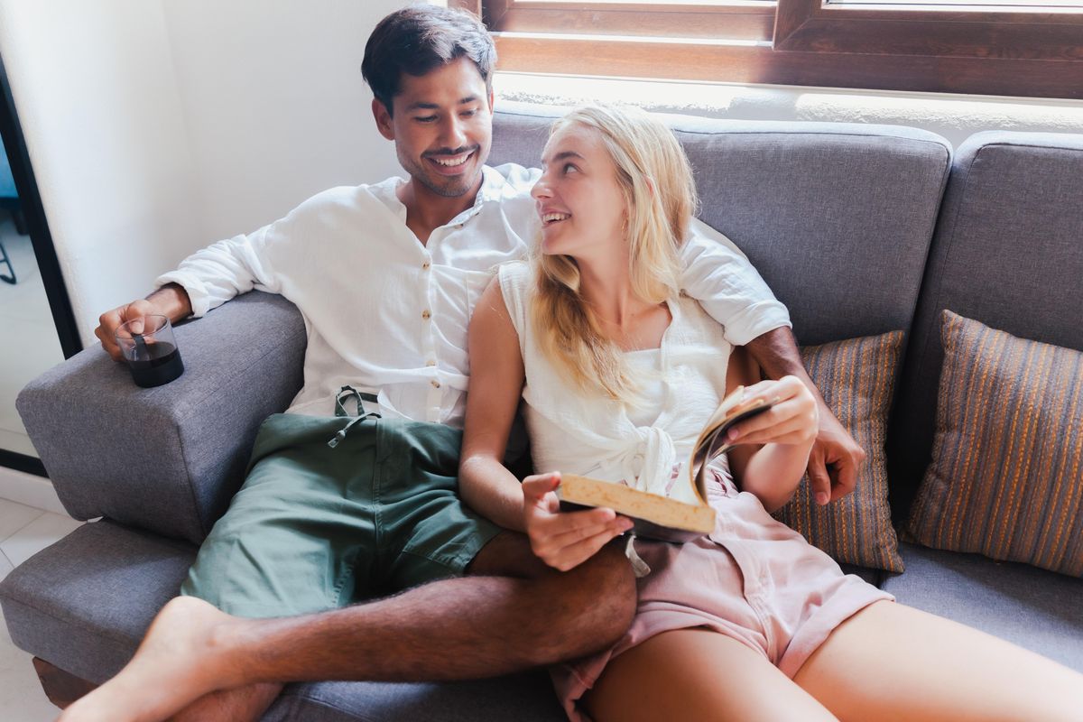 flirty couple laying on the couch