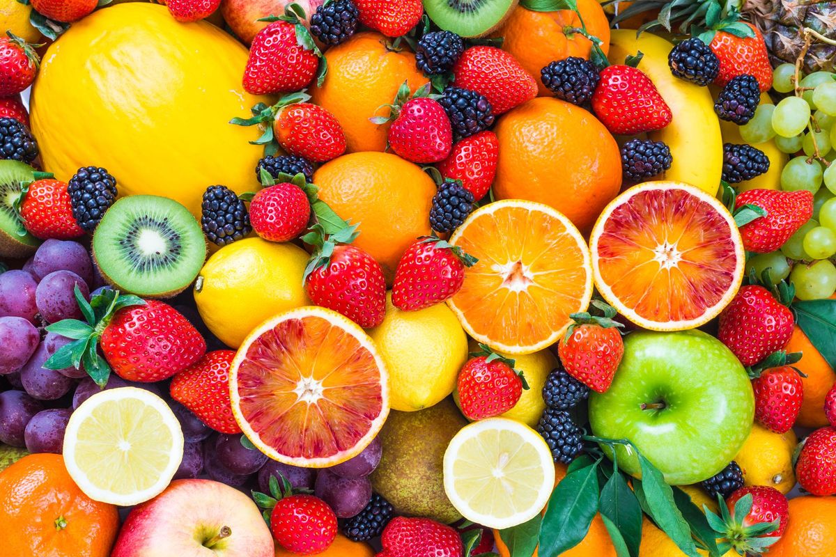 Fresh mixed fruits background.Organic fruits multicolor background.