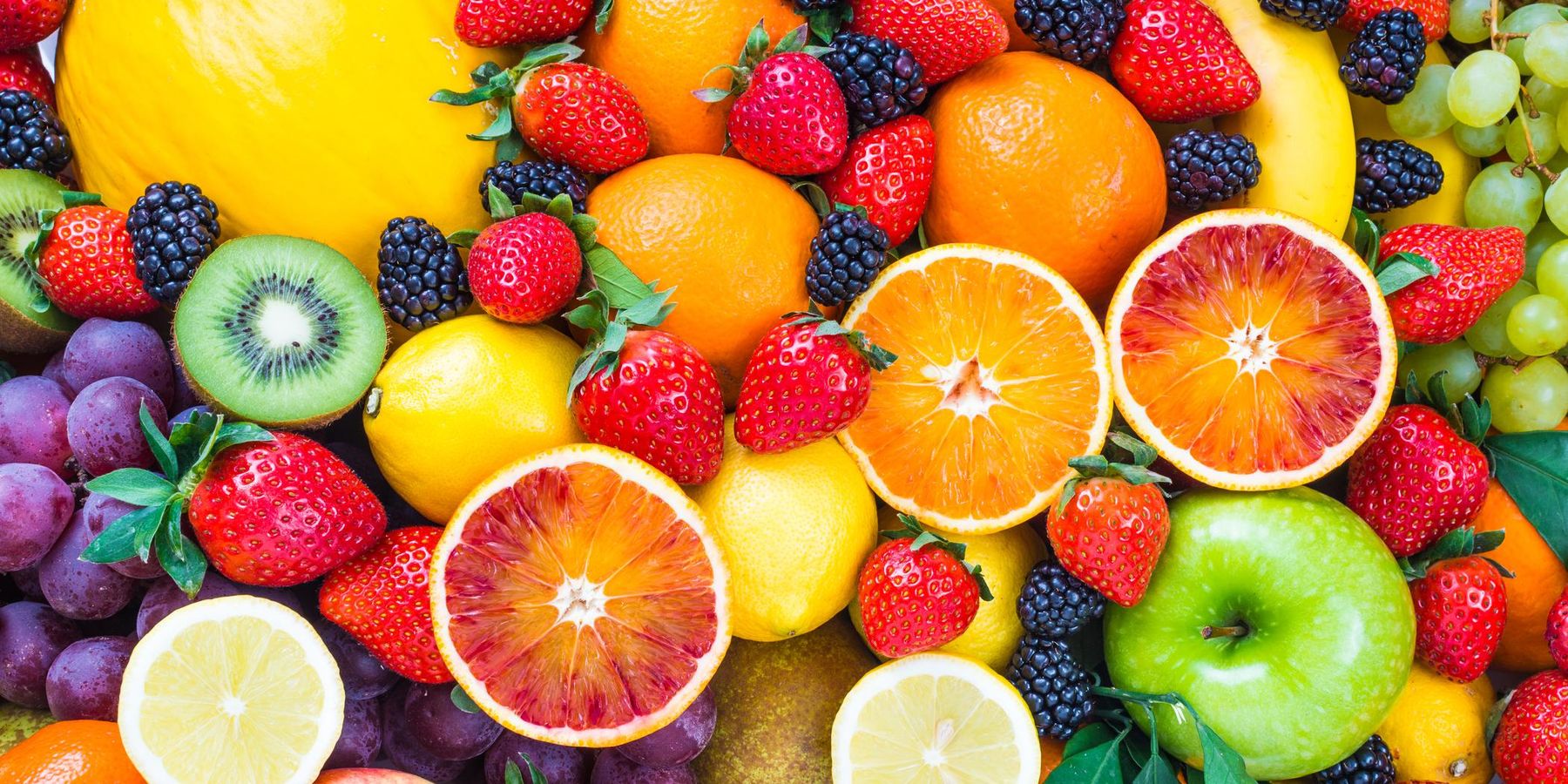 Fresh mixed fruits background.Organic fruits multicolor background.