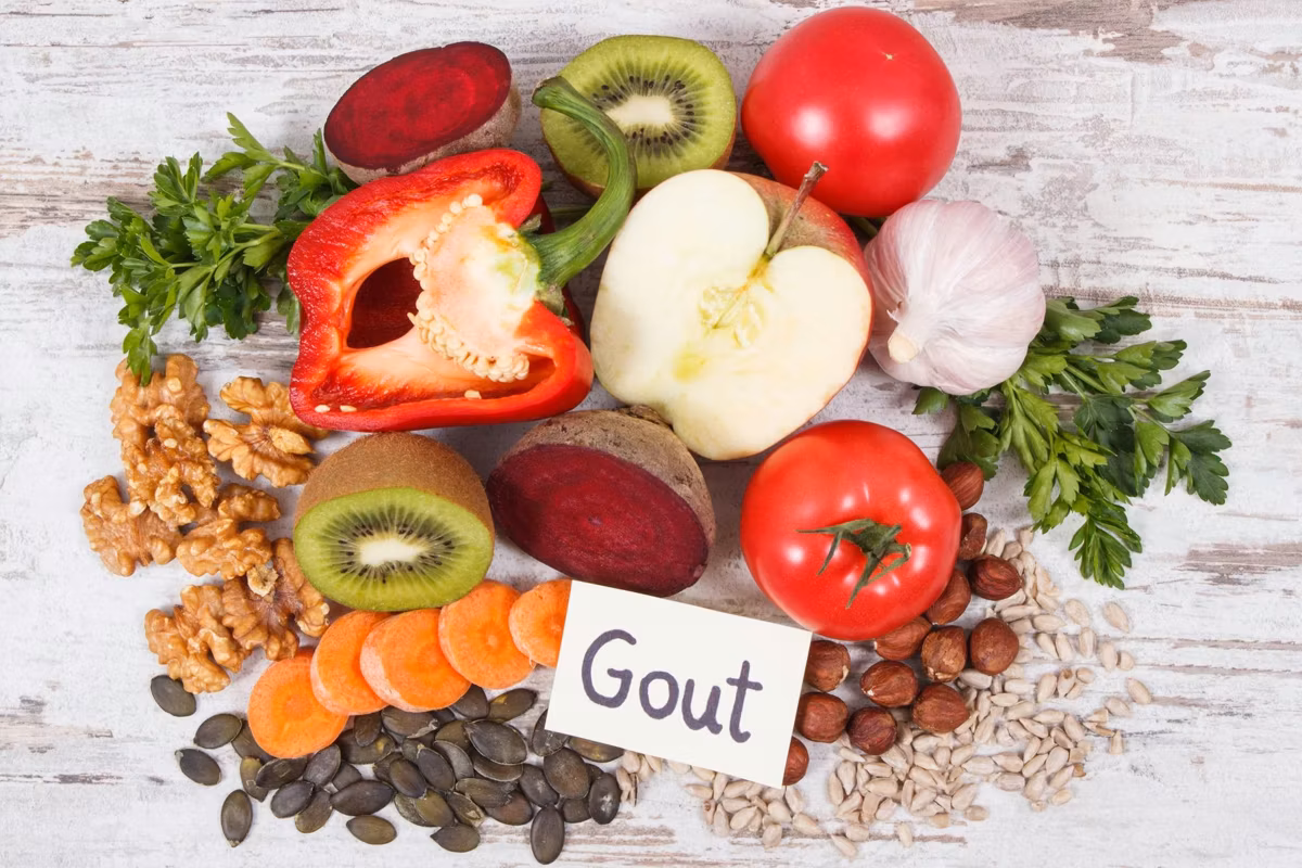 fruits and vegetables on a table with a sign saying gout