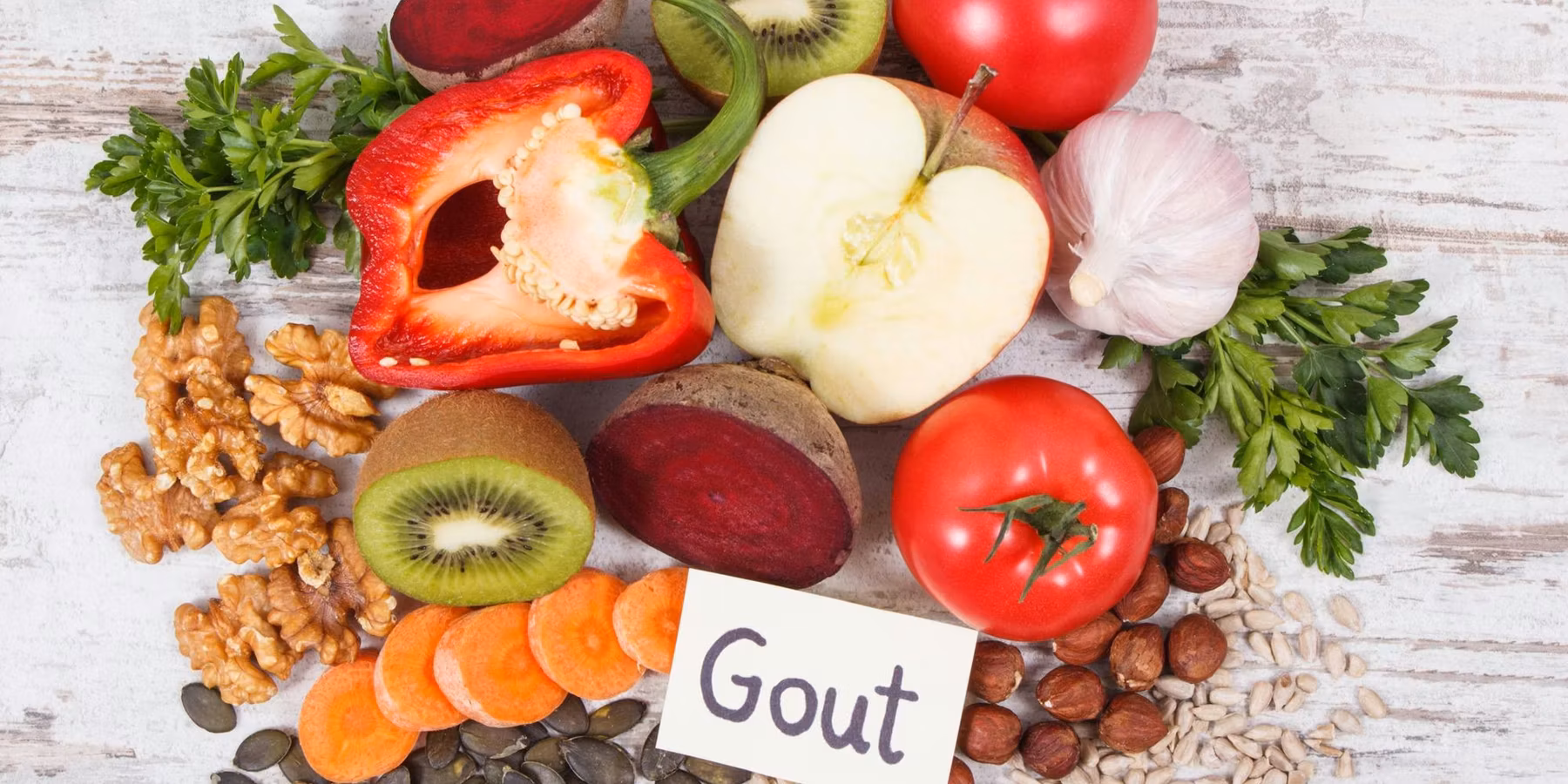 fruits and vegetables on a table with a sign saying gout