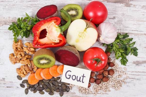 fruits and vegetables on a table with a sign saying gout