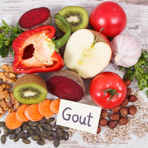 fruits and vegetables on a table with a sign saying gout