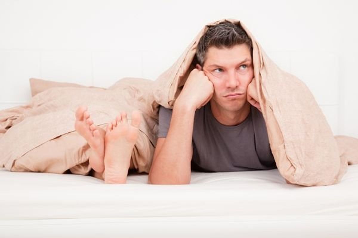 frustrated couple laying in bed