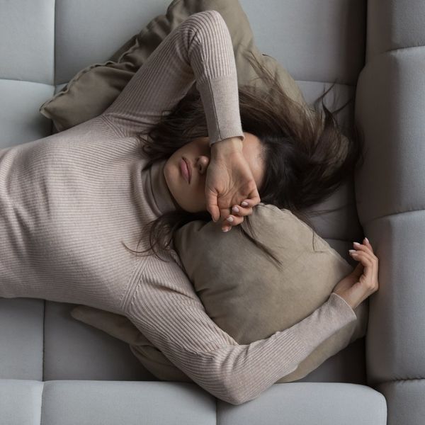girl lying on back on comfortable couch at home