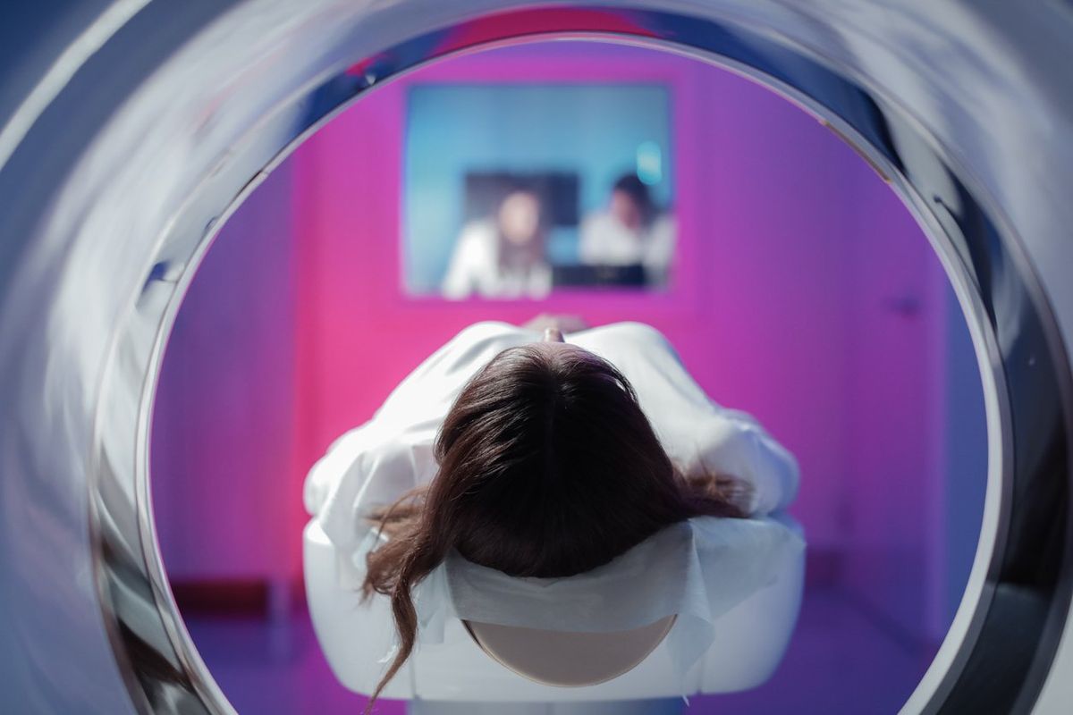 girl patient is lying in the tomograph and waiting for a scan