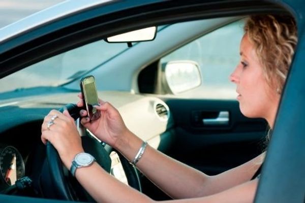 girl texting while driving