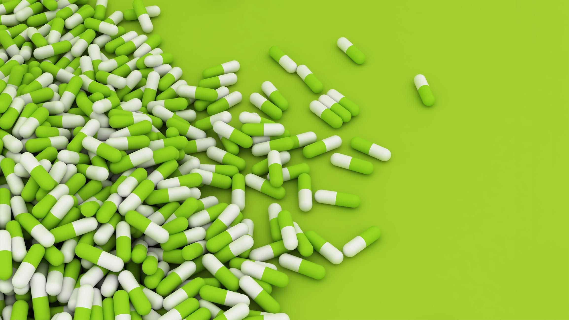Green pills on green background