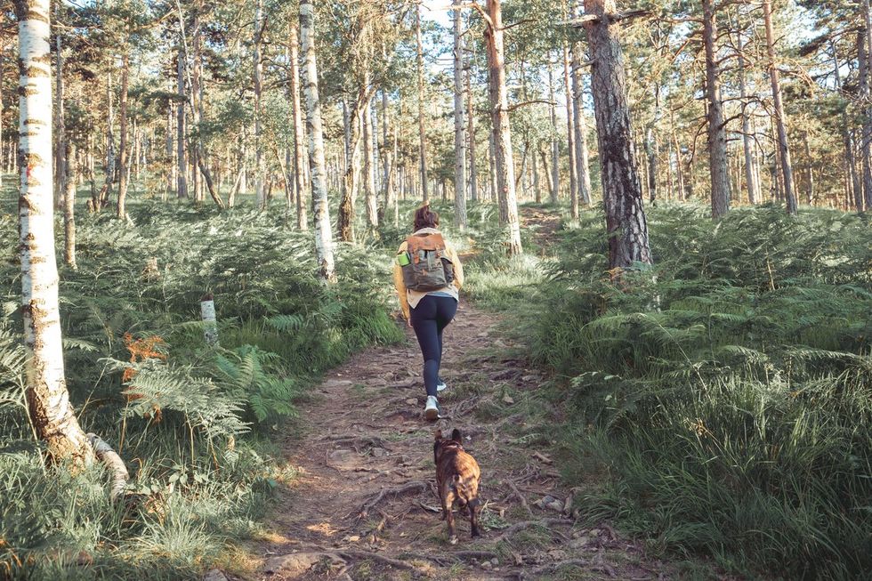 grieving woman in nature with dog