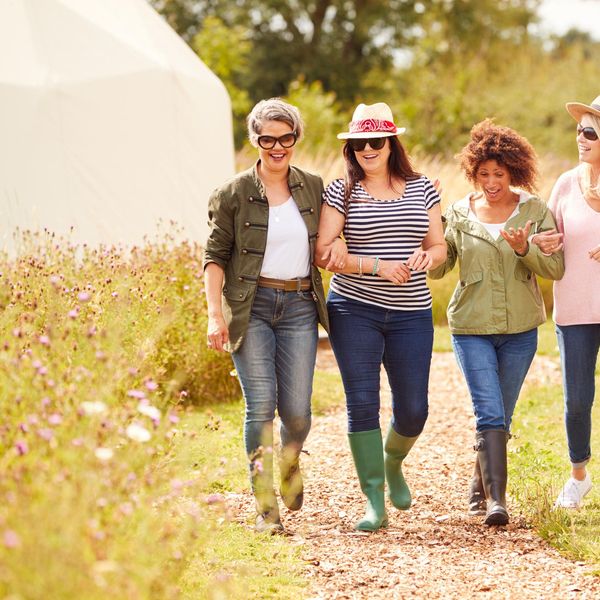 Group Of Mature Female Friends Walking Along Path