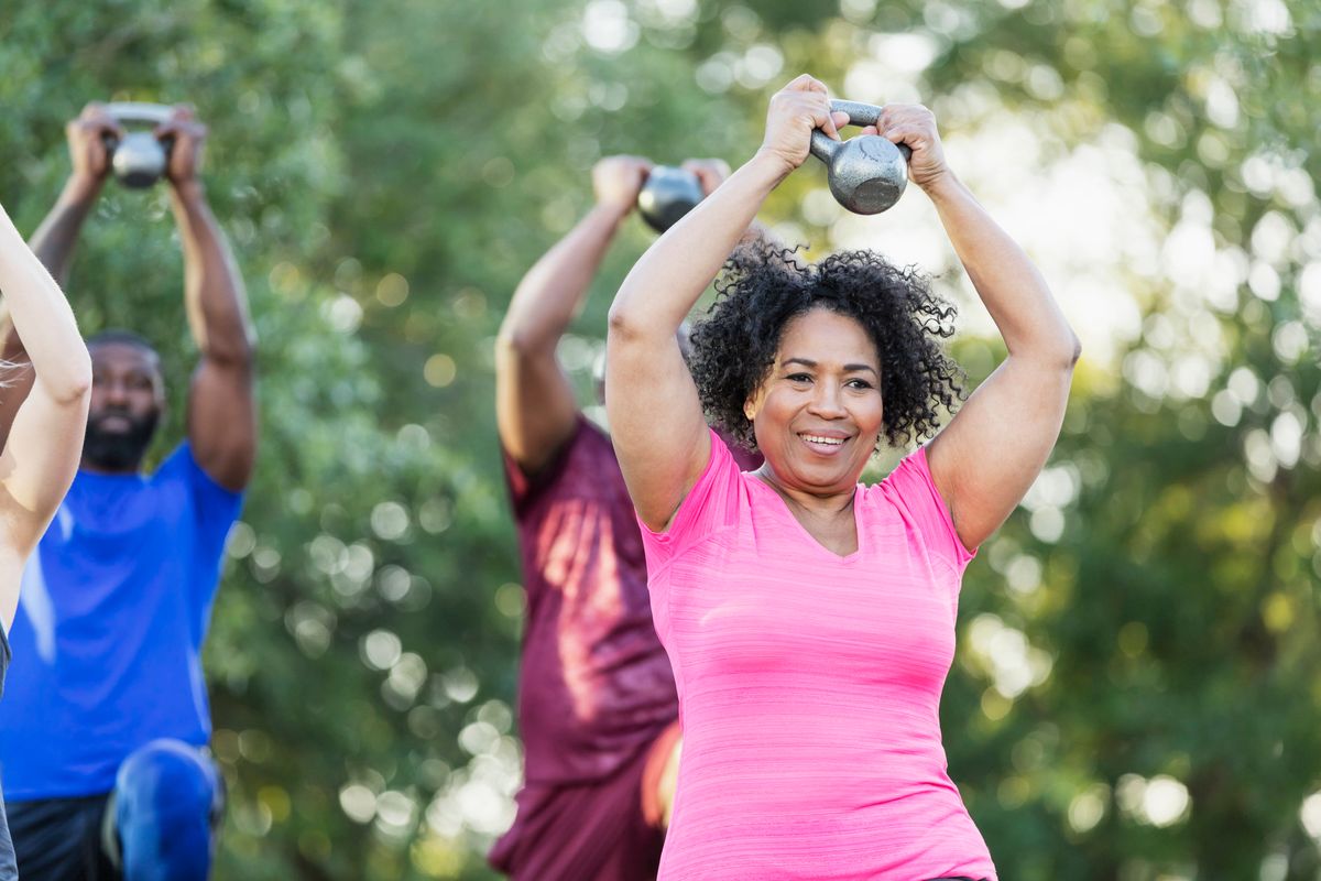 group of people of mixed ages in an exercise class outdoors
