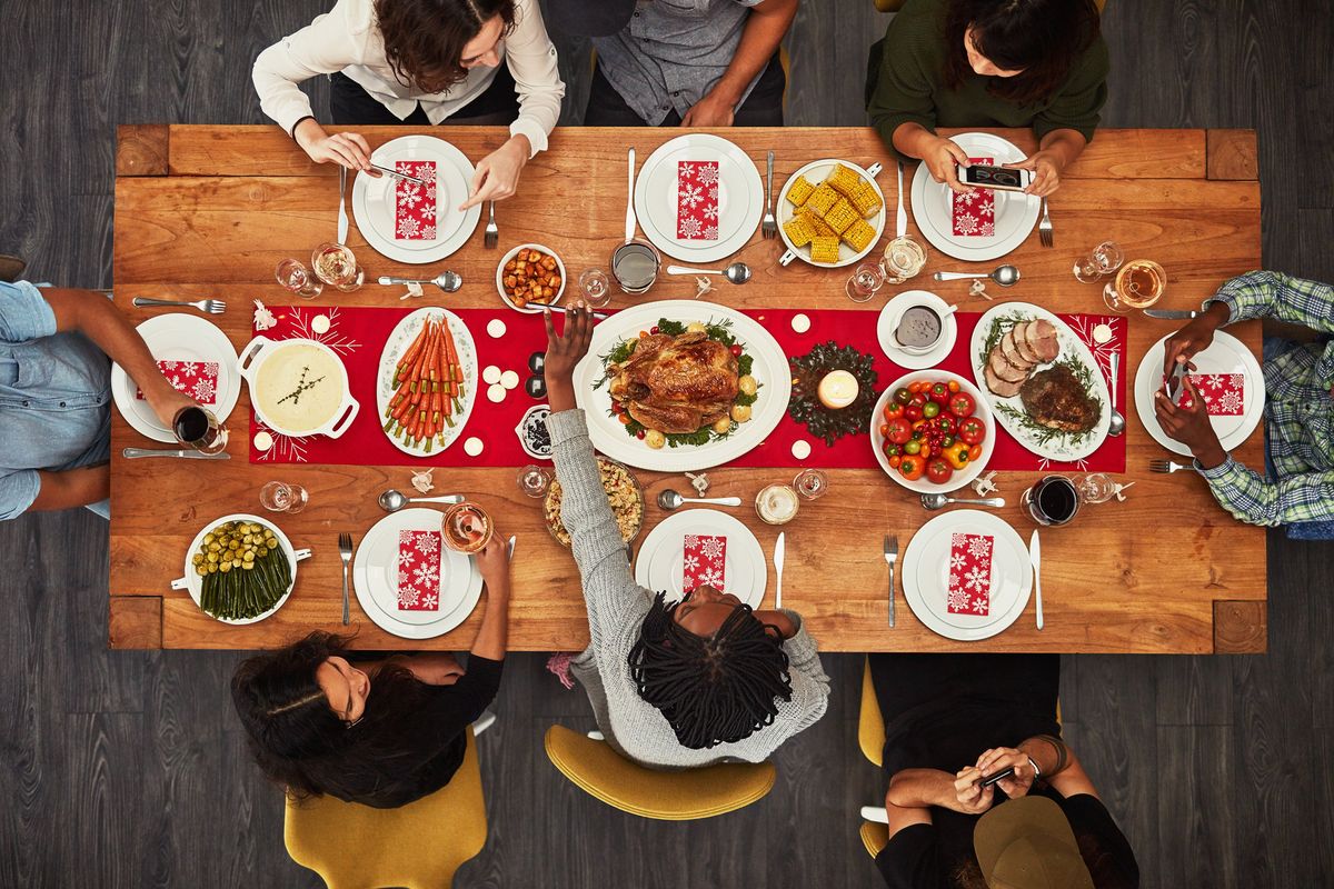 group of people sitting together at a dining table ready to eat