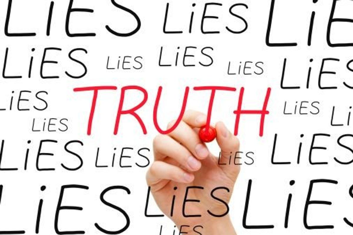 hand writing the word lies
