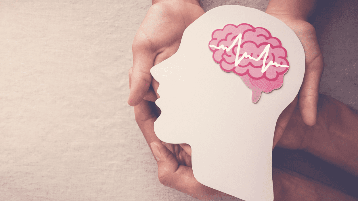 hands holding an image of a brain