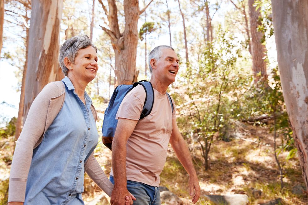 happy Couple Hiking Along Forest Path Together