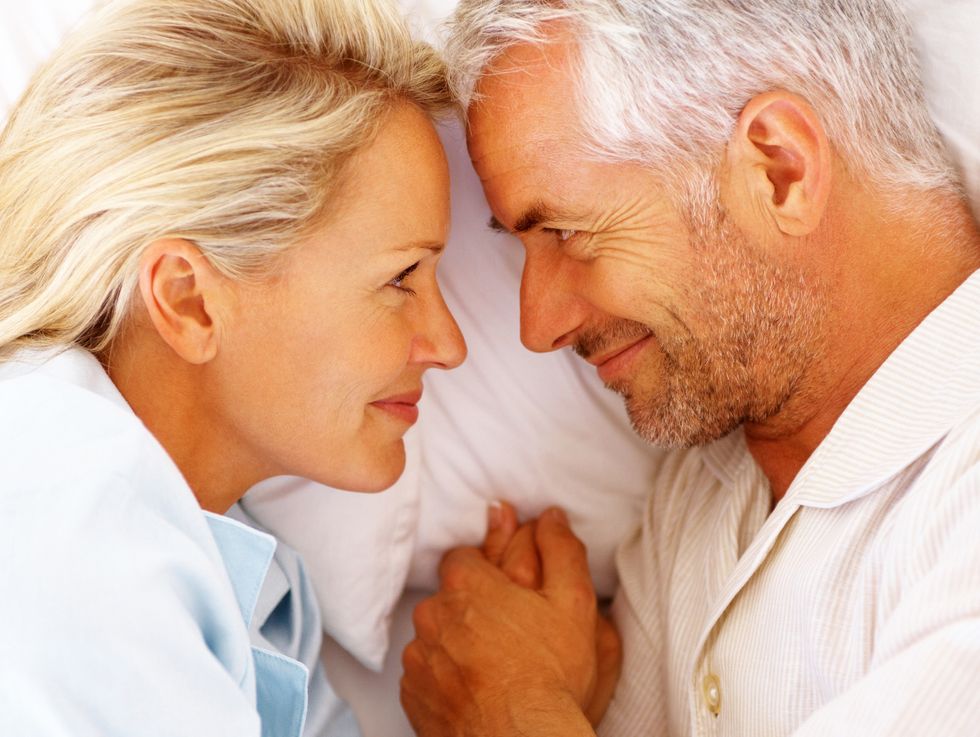 Happy mature couple in bed
