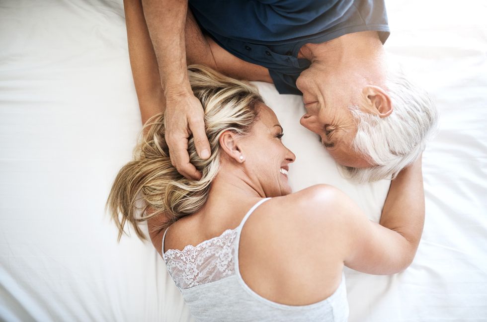 happy older couple in bed