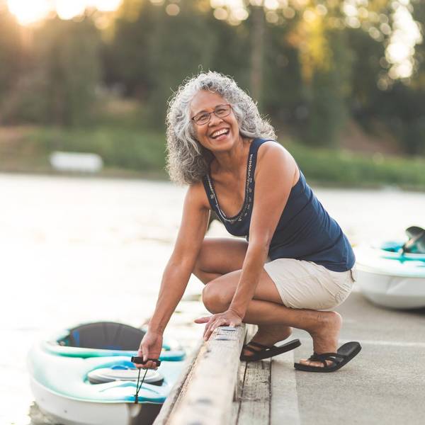 Happy senior woman on a kayaking trip