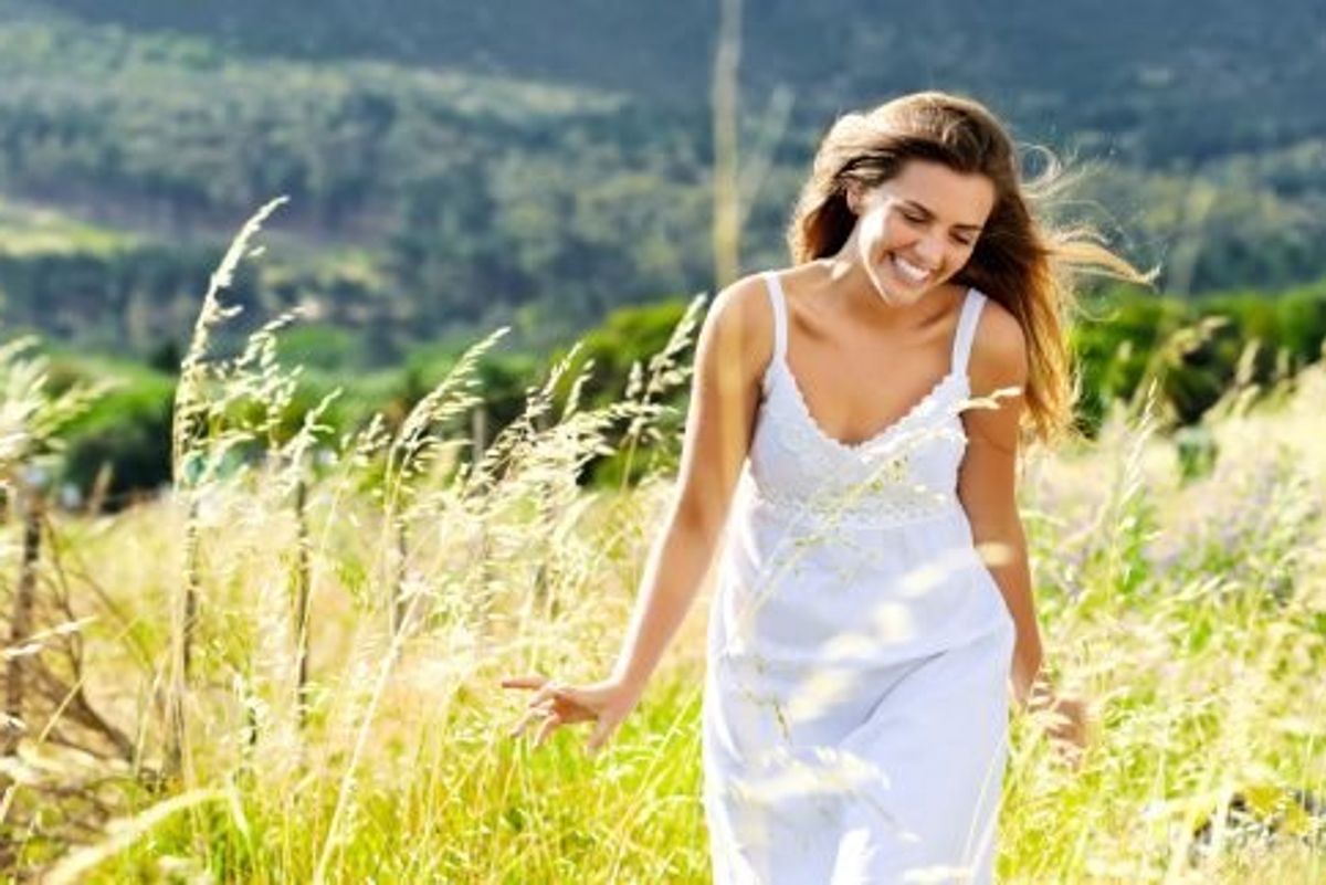 happy woman walking in a field