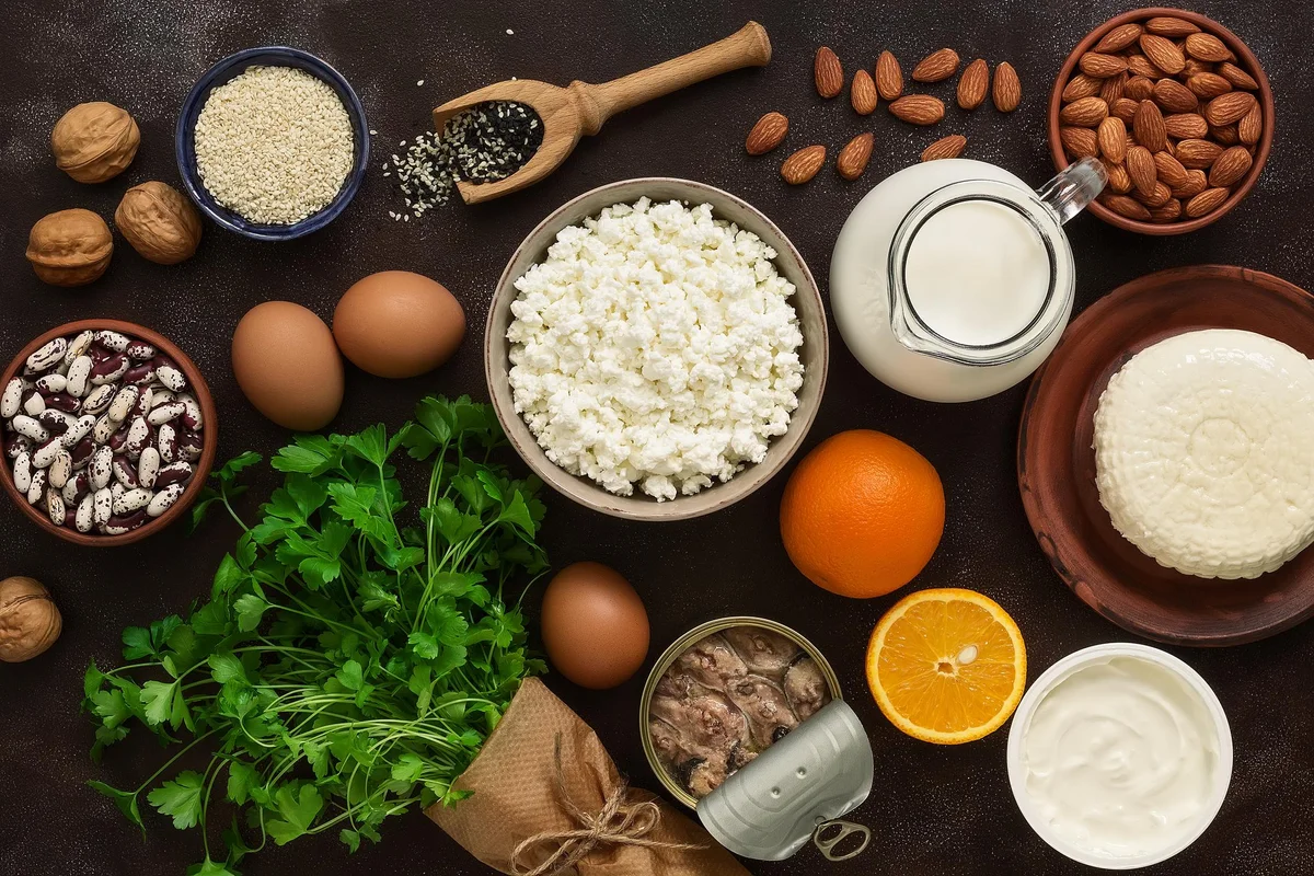 High calcium foods. Dairy products, beans, sardines, fruits, nuts. Nutrition for the healthy bones. Top view, flat lay