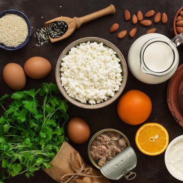 High calcium foods. Dairy products, beans, sardines, fruits, nuts. Nutrition for the healthy bones. Top view, flat lay