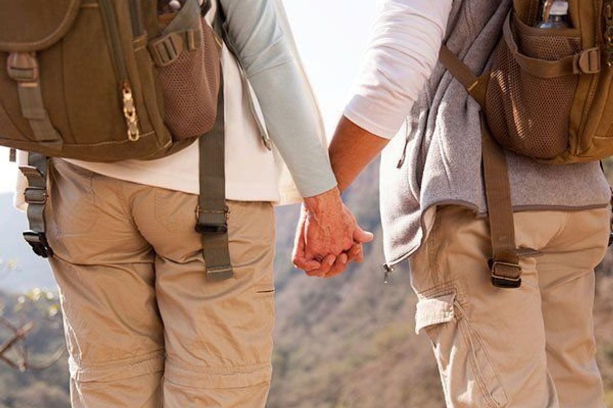 hiking couple holding hands