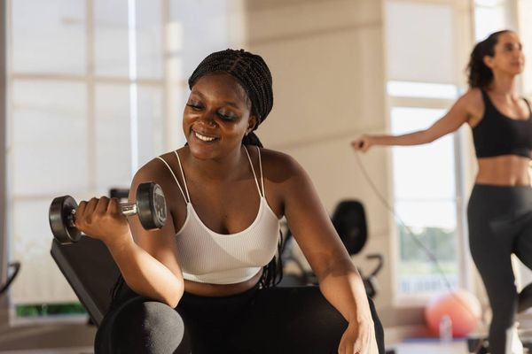 holding dumbbells lifts weights exercise in gym